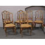 A set of six bergere seat chairs raised on cabriole legs.