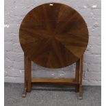 A quarter veneered circular folding occasional table.