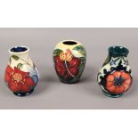 Three Moorcroft vases including one decorated with poppies over green ground.Condition report