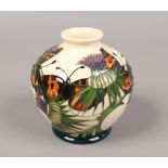 A Moorcroft ivory ground squat vase, decorated with thistle and butterflies.Condition report
