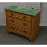 A Victorian satinwood chest of three drawers.