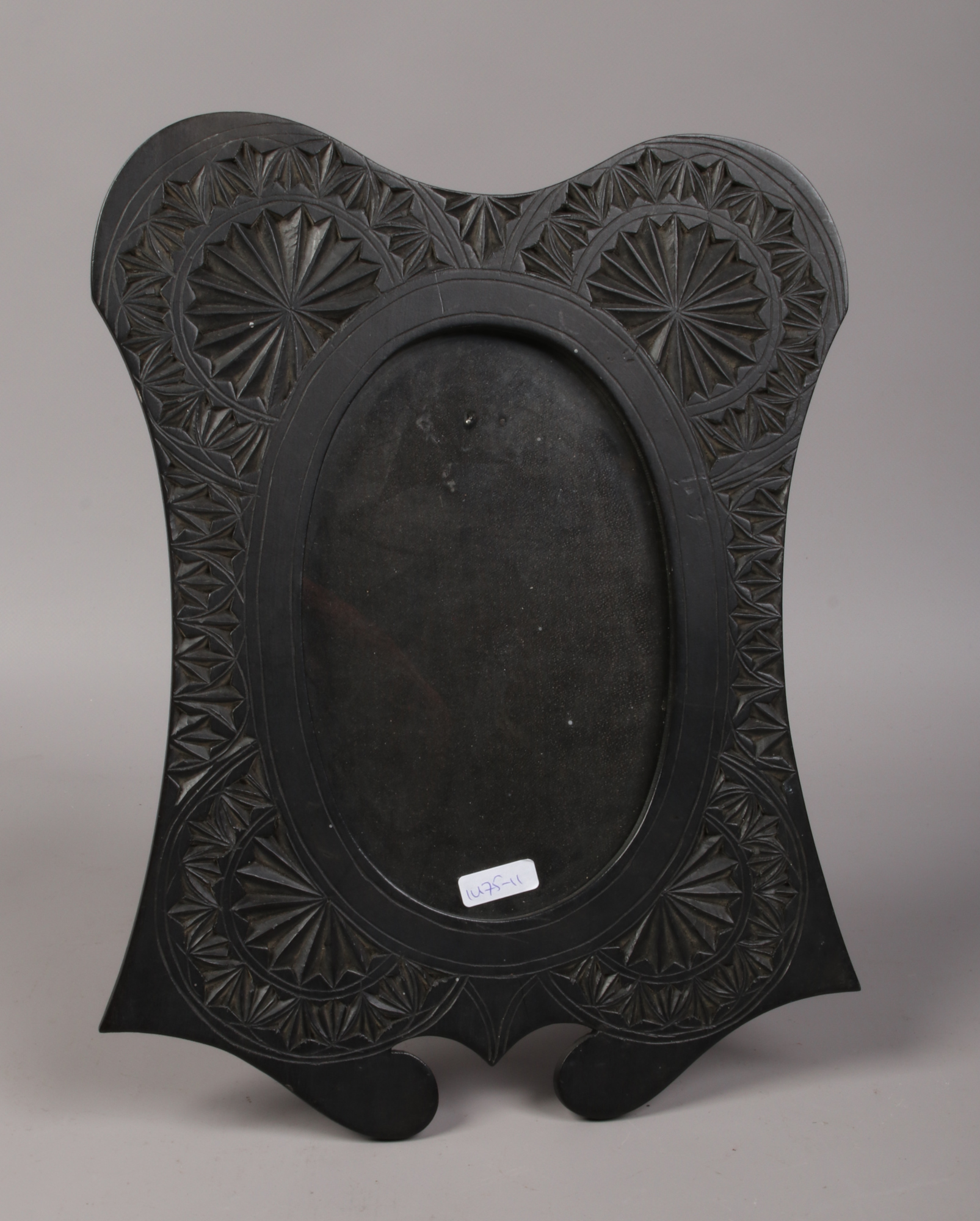 An Anglo Indian carved and ebonised strut photo frame.