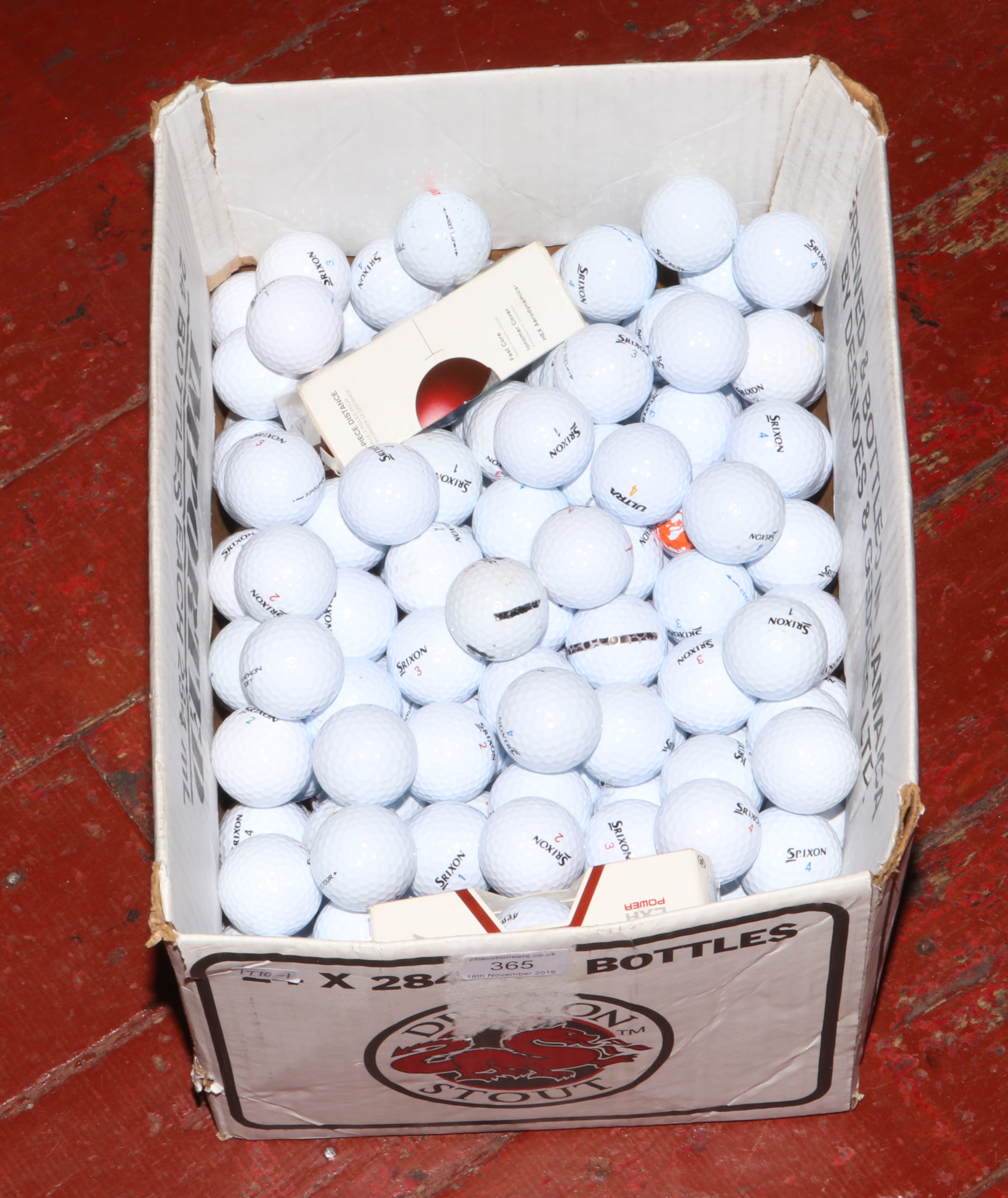 A box of mainly Srixon golf balls.