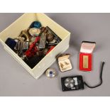 A box of collectables to include multi tools, coins, Zaima lighter etc.