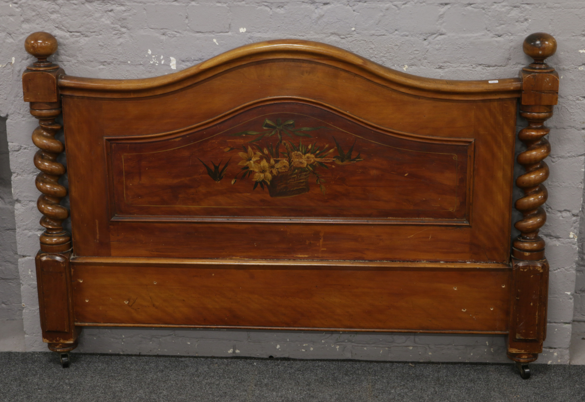 A mahogany head board with barleytwist supports and painted panel.