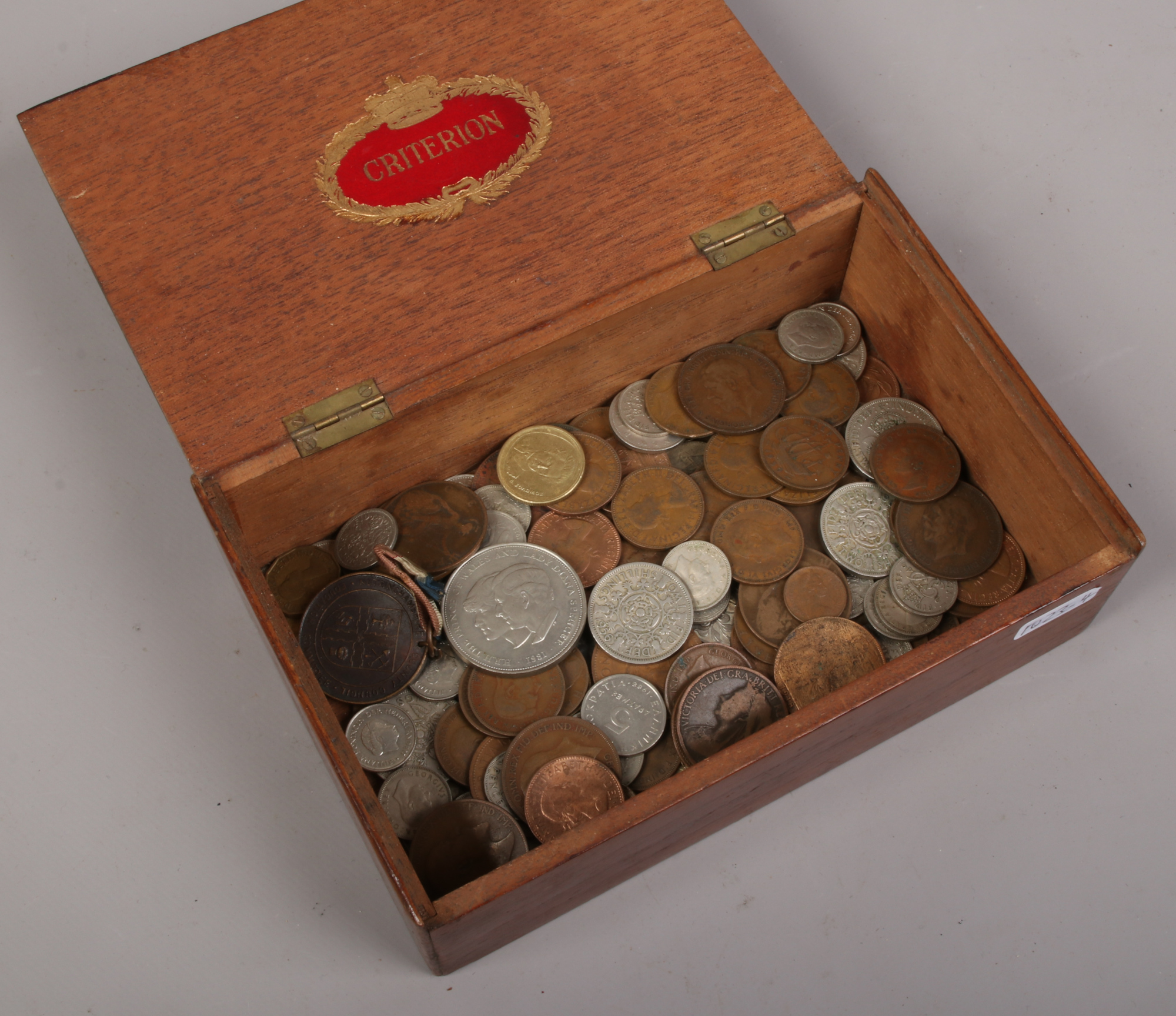 A box of mainly British pre-decimal coins.