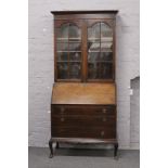 A Victorian mahogany bureau bookcase with fitted interior raised over carved cabriole legs, Width