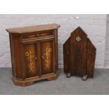 An Art Deco oak firescreen and a marquetry side cabinet.