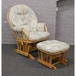 An upholstered spindle back rocking arm chair and matching rockingham footstool, by Dutailier.
