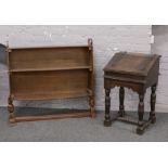 A carved oak bible box with iron mounts, raised on turned and square cut supports, along with a