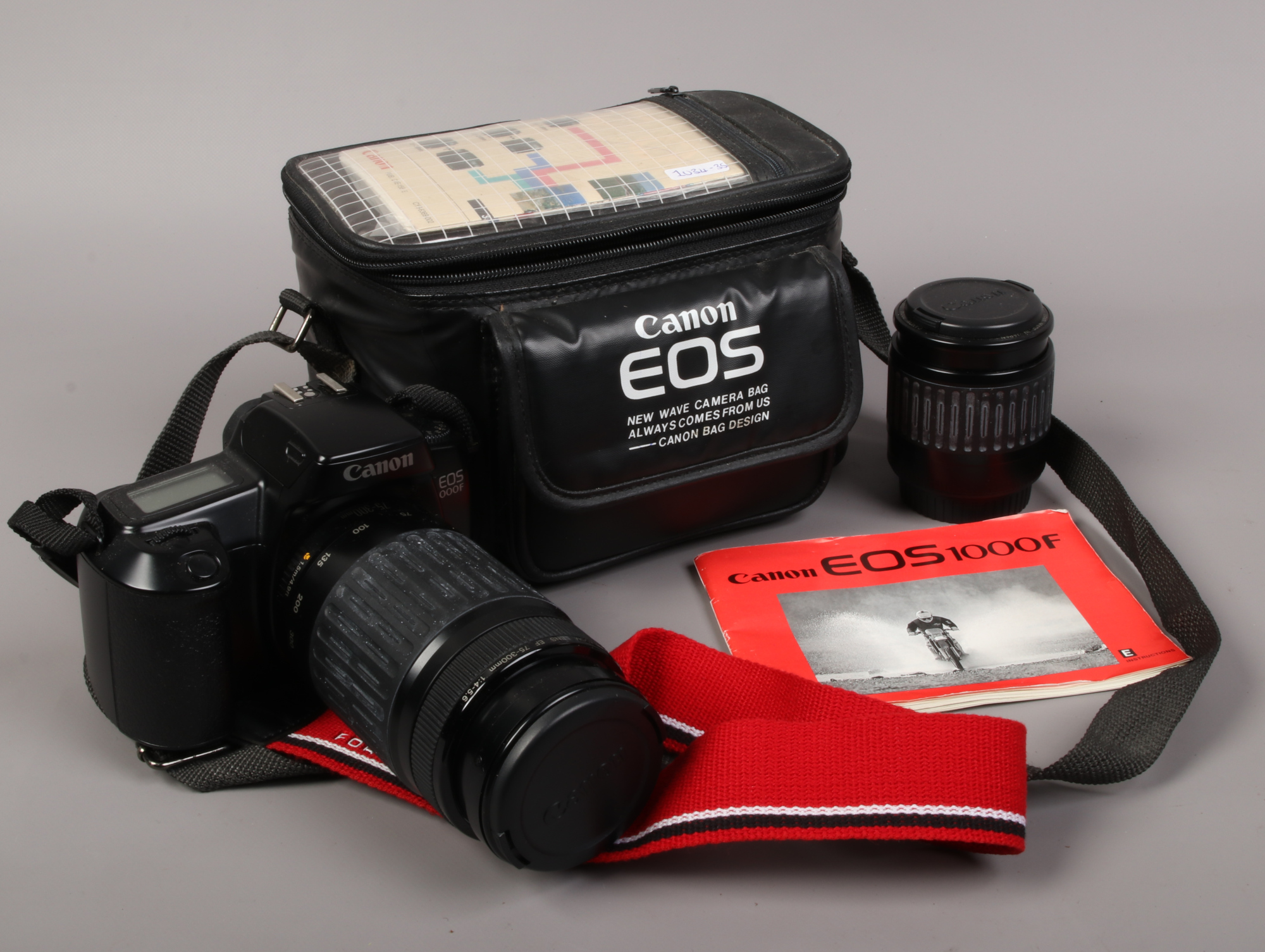 A Canon EOS 1000F camera, along with another Canon lens, in original maker carry bag.