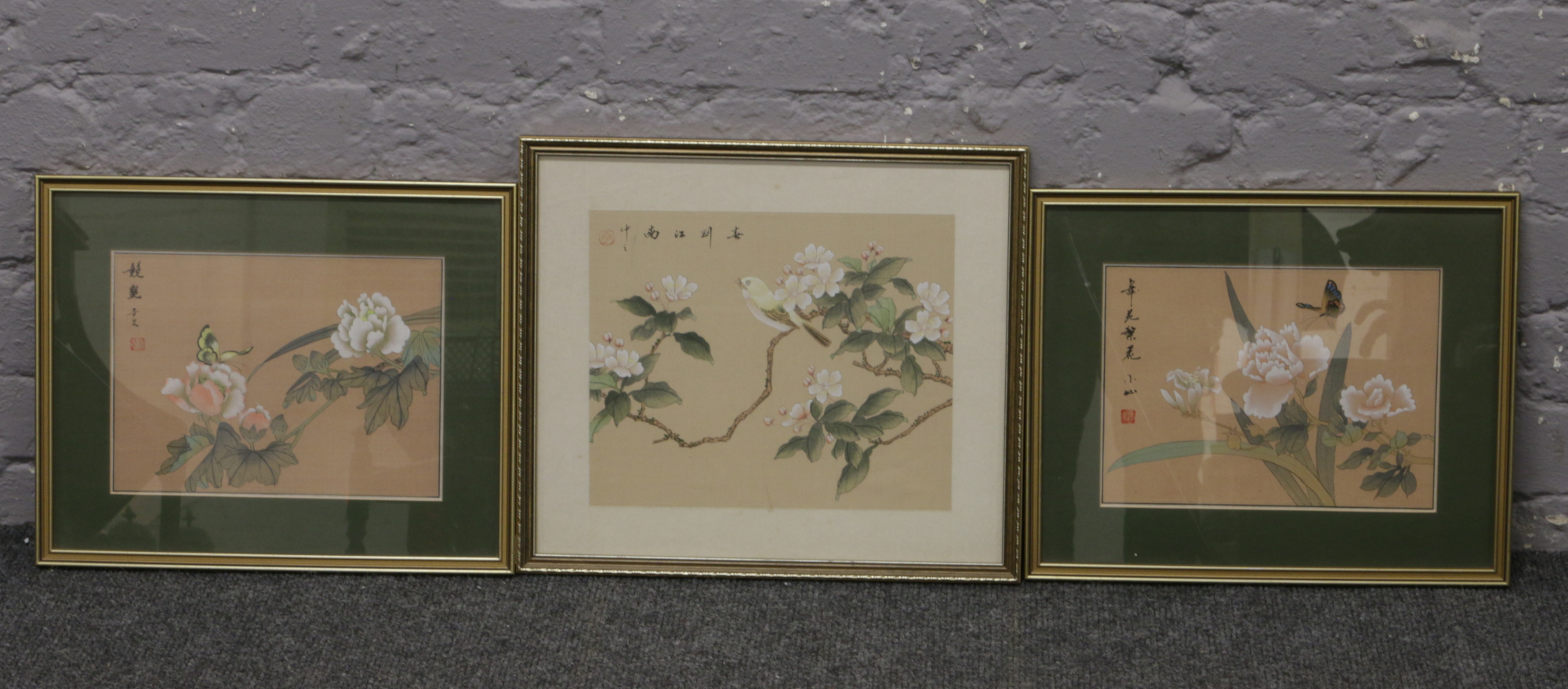 Three gilt framed Chinese paintings on silk of flowers.