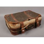 A Louis Vuitton leather bound suitcase stencilled R.G.