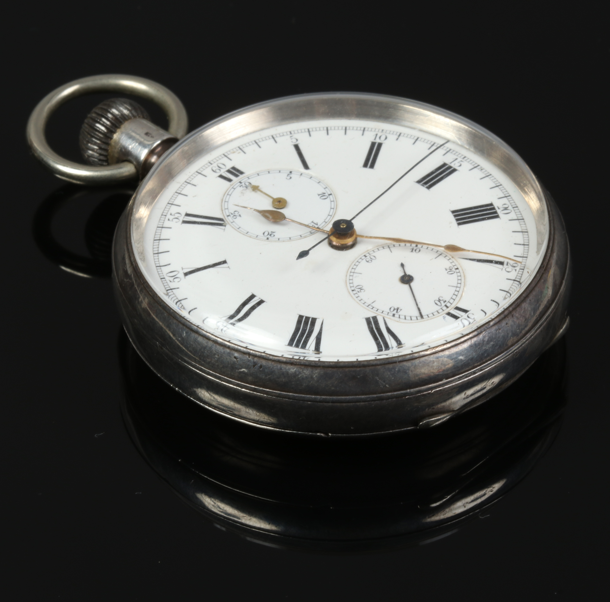 A silver chronograph pocket watch with subsidiary dial and Roman numerals marks, curvette also