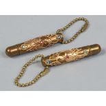 A pair of 1951 gilt cased miniature pens decorated with three coloured paste stones.