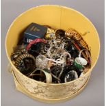 A hat box of costume to include beads, bangles, necklaces etc.