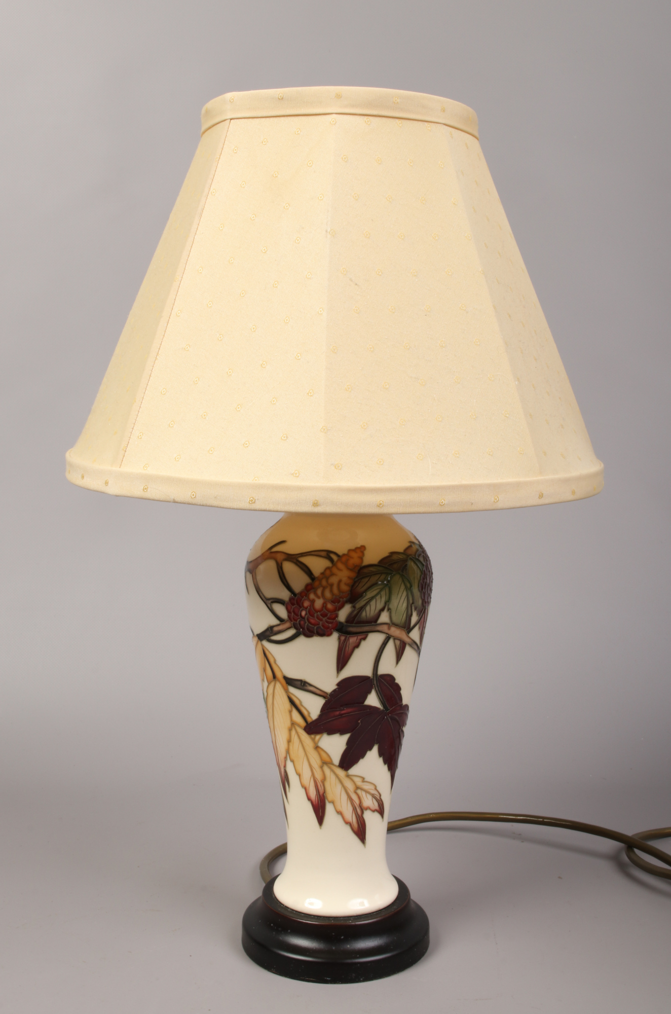 A Moorcroft ivory ground high shouldered table lamp decorated with Autumnal trailing foliage with