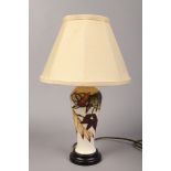 A Moorcroft ivory ground high shouldered table lamp decorated with Autumnal trailing foliage with