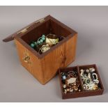A pine and brass jewellery chest to include bangles, beads, earrings etc.