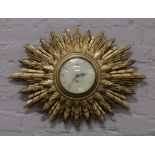 A Smiths gilt double sunburst wall clock.