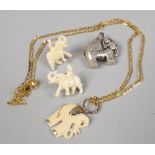 A pair of carved bone elephant earrings and similar pendants.