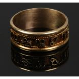 A yellow metal band decorated with signs of the Zodiac, stamped 18K (not tested) size V, 4.8 grams.