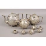 An Indian silver tea service of spherical form, comprising teapot, sugar bowl, hot water jug, cruets