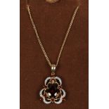A 9ct gold garnet and diamond pendant on gold chain.