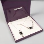 A cased silver willow pendant on chain and bracelet set each piece set with black hardstone cabachon