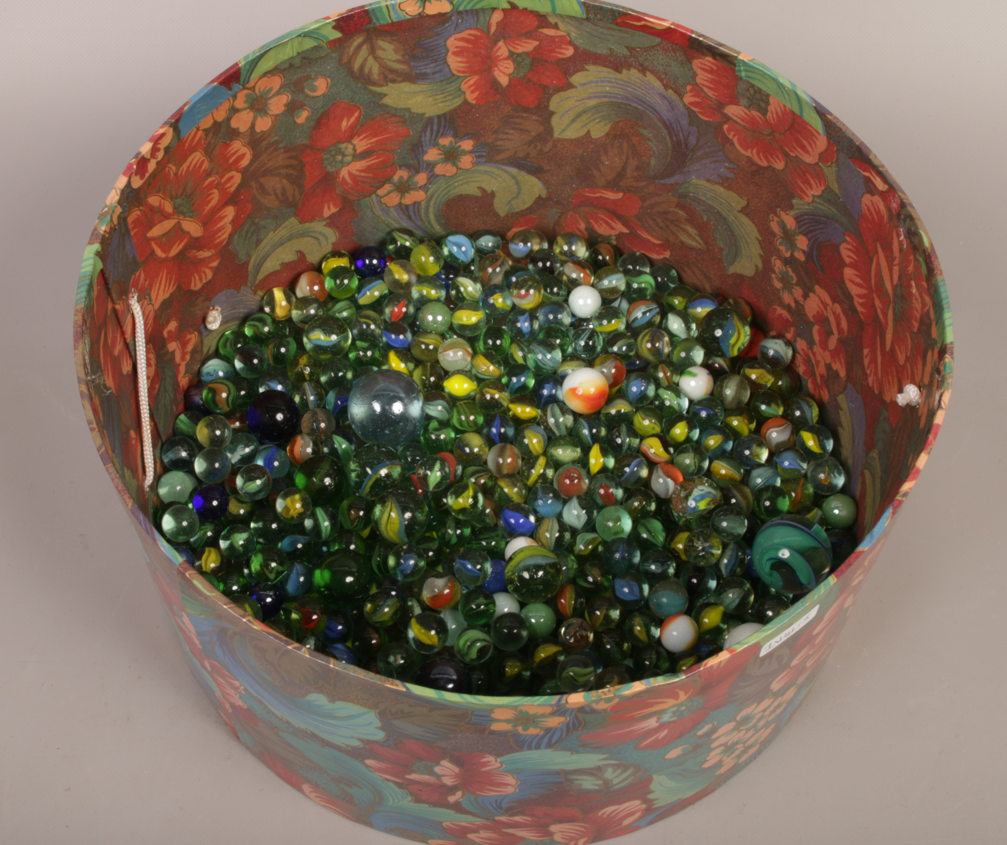 A box of marbles of various sizes polychrome and vintage.