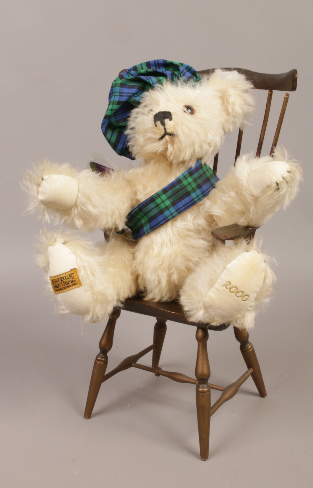 A Merrythought Limited edition Hogmanay teddy bear in Windsor armchair.