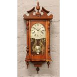 A mahogany cased Maxim 31 day wall clock chiming on a gong with pendulum and key.