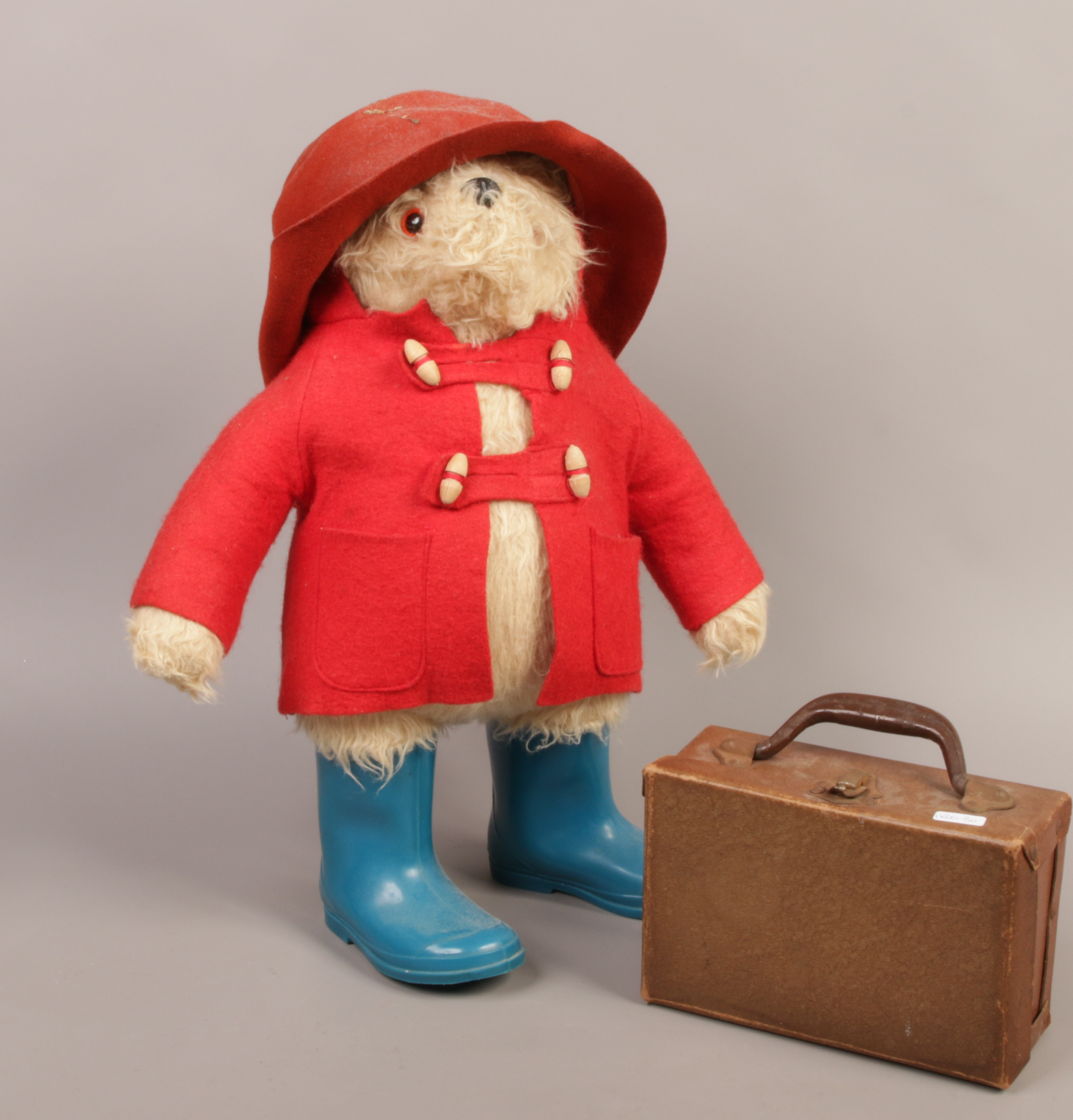 A Gabrielle design Paddington Bear soft toy c.1980 with hat overcoat, wellingtons and suitcase.