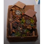 A box of vintage cuckoo clocks for spares / repair.