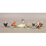 An assembled set of Wade ceramic Disney's Snow White and the Seven Dwarfs figures.