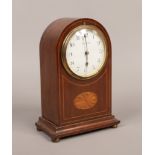 An early 20th century mahogany cased dome top mantle clock with boxwood strung inlay and white