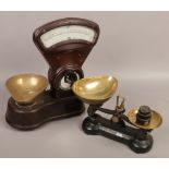 A set of vintage Bakelite shop scales by Asco, along with a cast iron set of scales.