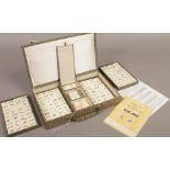 A cased vintage bone and bamboo Chinese Mahjong set.