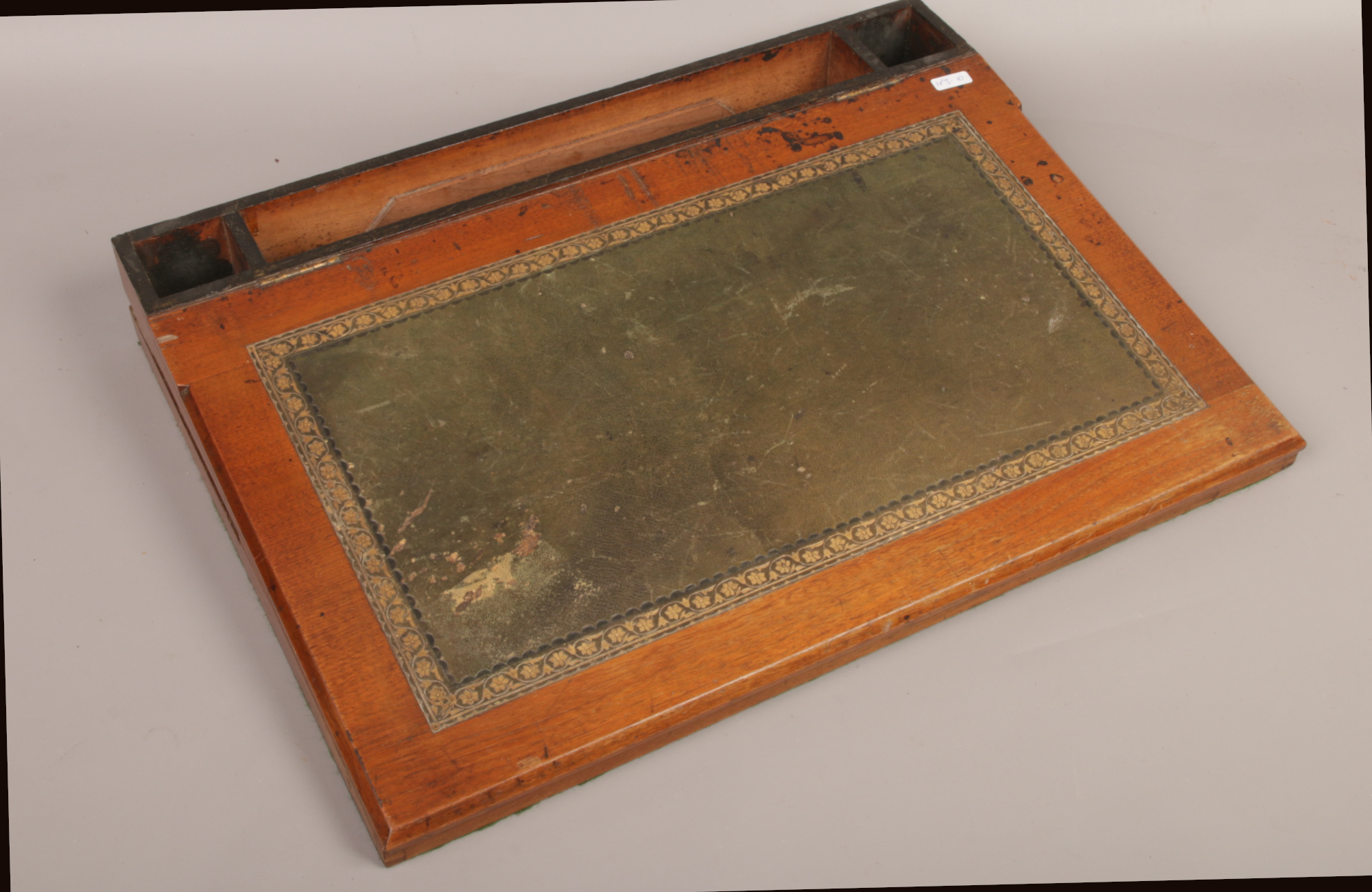 A mahogany table top writing slope inlaid with tooled leather.