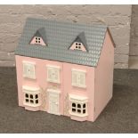 A painted dolls house and contents of dolls furniture to include stairs, figures, cupboards etc.