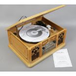 A vintage style wooden cased music system with turntable, radio, C.D and cassette player, maker