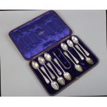 A cased part set of 11 Victorian silver teaspoons and pair of sugar tongues by Chawner & Co. assayed