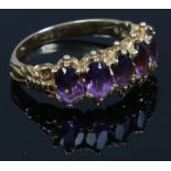 A 9ct gold five stone amethyst ring set with ovoid cut stones. Size P.