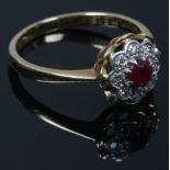 A vintage 18ct gold and platinum ruby and diamond floriform cluster ring, size P.