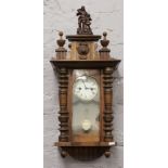 An early 20th century walnut cased Vienna wall clock with 8 day spring driven movement and