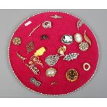 A pad of vintage costume jewellery brooches including simulated pearls, white paste and marcasite