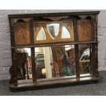 An early 20th century overmantle mirror with turned supports and a two tier shelf.