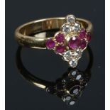 An 18ct gold ruby and diamond cluster ring. Size N 1/2.