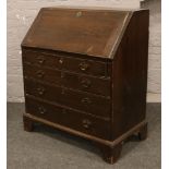 A Georgian carved oak bureau over four drawer chest with fitted interior, 96cm W x 52cm D x 87cm H.