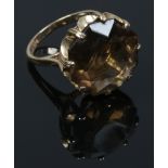 A 9ct gold cocktail ring set with a large smoky quartz stone, size L.